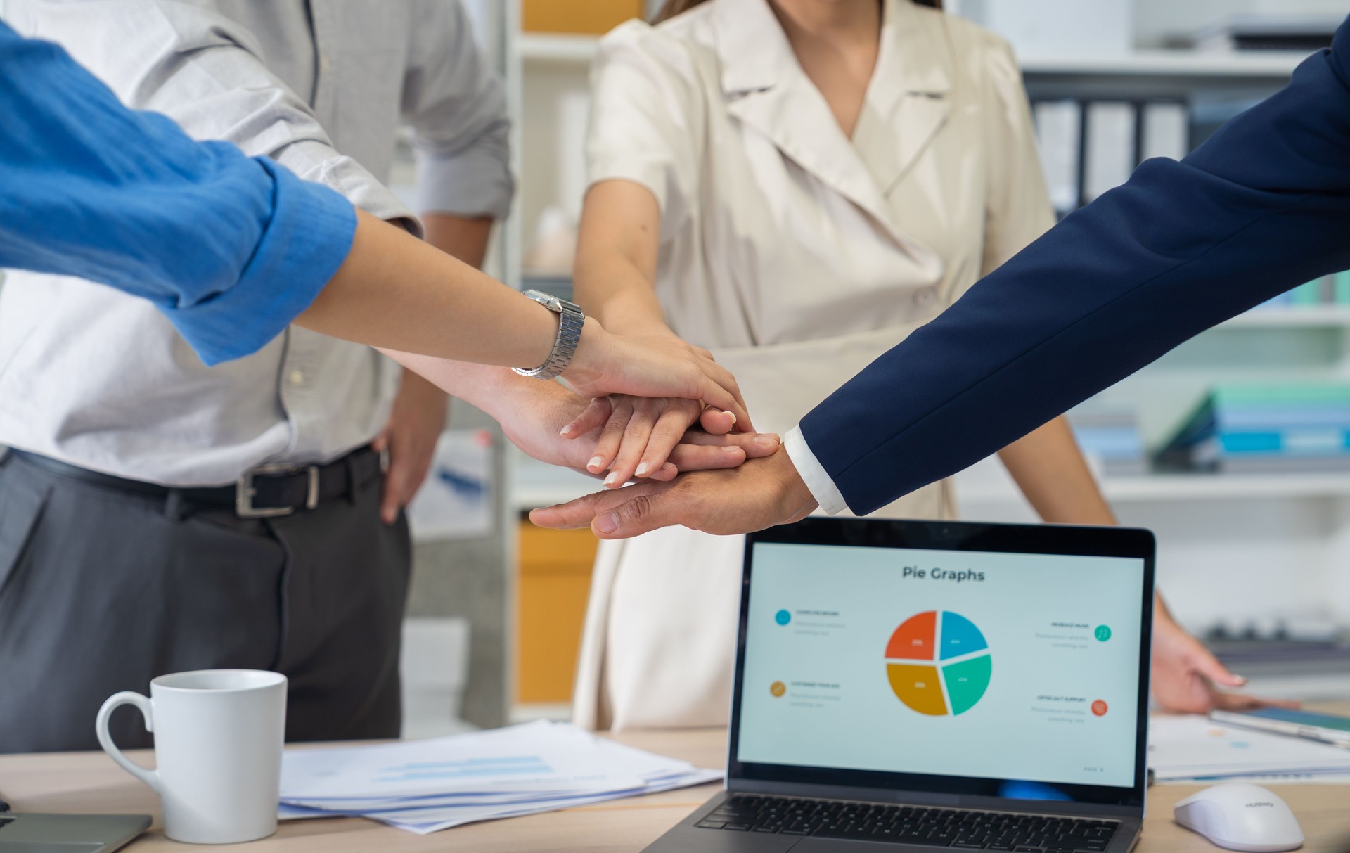 Creative business team enjoying coffee and a casual meeting conversation during a break in a modern office. A relaxed teamwork, informal collaboration, work-life balance in a contemporary workplace